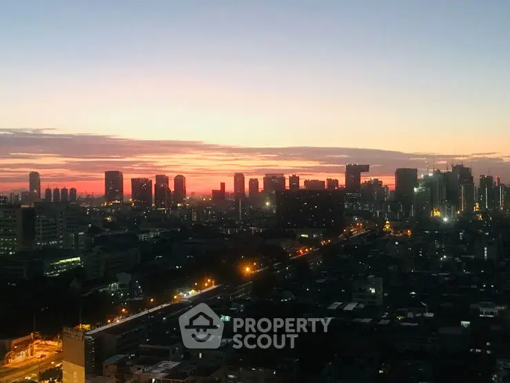 Stunning city skyline view at sunset with vibrant colors and illuminated buildings.