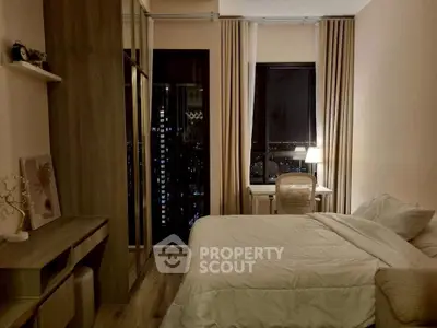 Cozy bedroom with city view, modern furnishings, and ambient lighting for a serene atmosphere.