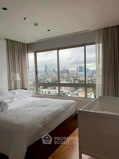 Spacious bedroom with stunning city view and natural light