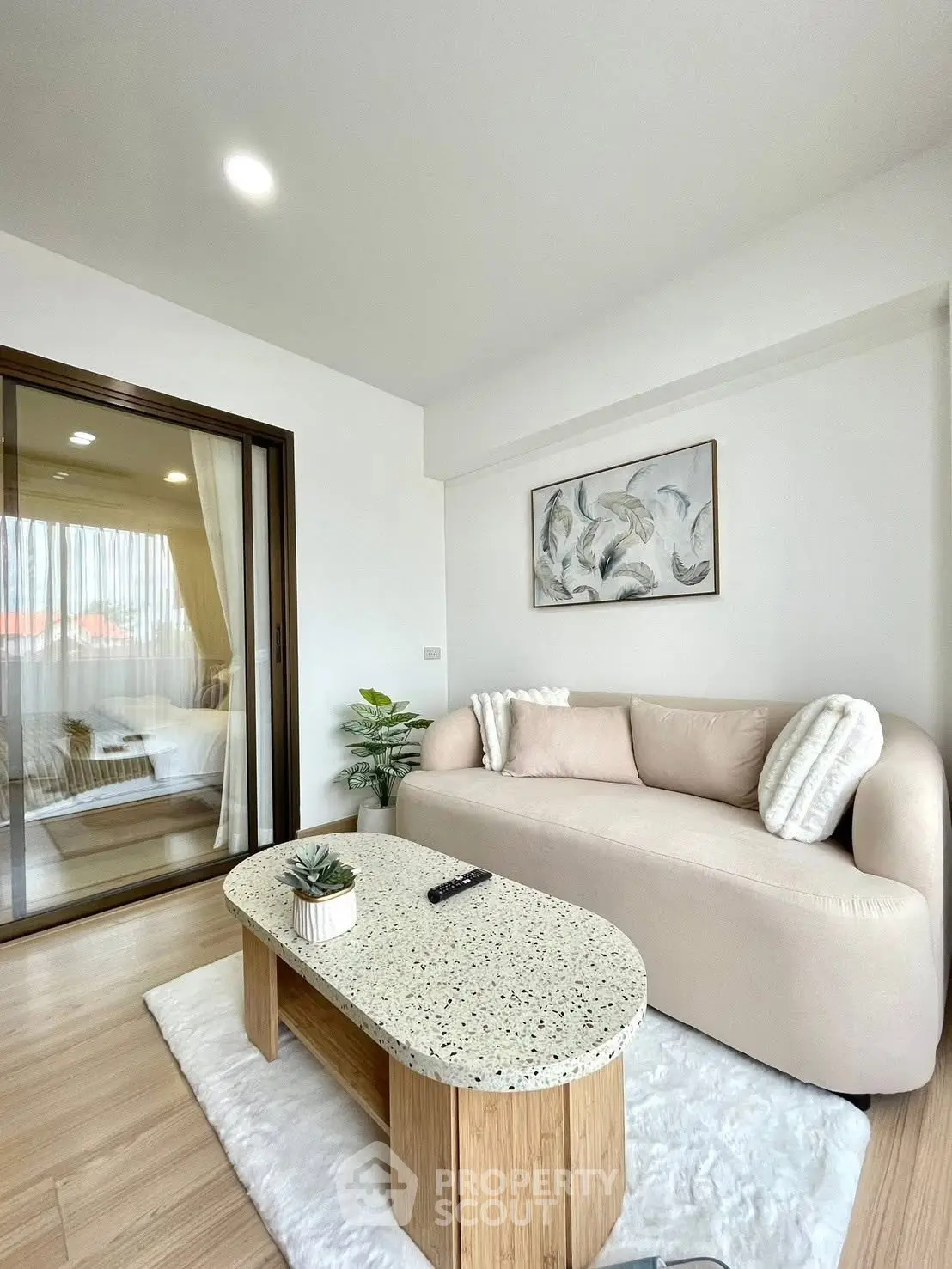 Modern living room with cozy beige sofa and stylish decor in a bright apartment.