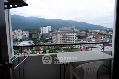 Stunning balcony view of cityscape and mountains, perfect for relaxation and enjoying the scenery.