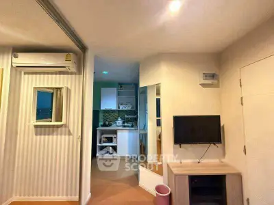 Cozy apartment interior with modern kitchen and living area, featuring air conditioning and stylish decor.