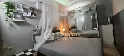 Cozy bedroom with mirrored wardrobe and elegant canopy bed design.