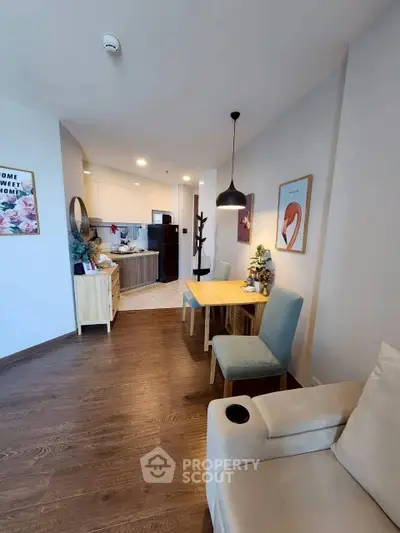 Modern open-layout living room with cozy dining area and stylish decor.