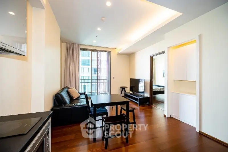 Modern living room with sleek design and open layout, featuring hardwood floors and natural light.