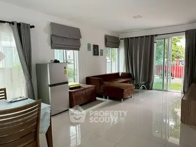 Spacious living room with modern furniture and large windows for natural light.