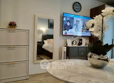 Modern living room with elegant decor and wall-mounted TV