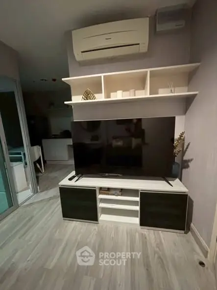 Modern living room with sleek TV unit and air conditioning, perfect for cozy entertainment.