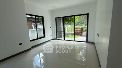 Spacious living room with large windows and garden view