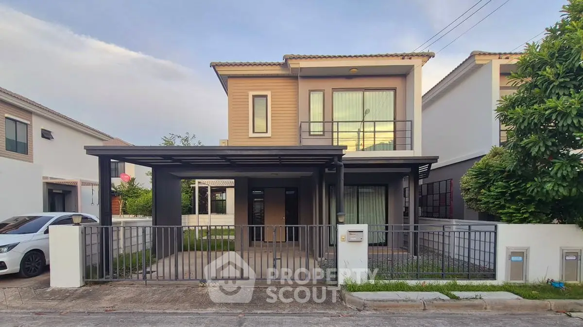 Modern two-story house with a spacious driveway and contemporary design.