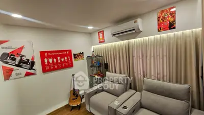 Cozy living room with modern recliners and sports-themed decor.