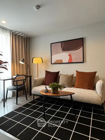 Modern living room with stylish decor, featuring a cozy sofa, chic artwork, and a sleek desk area.