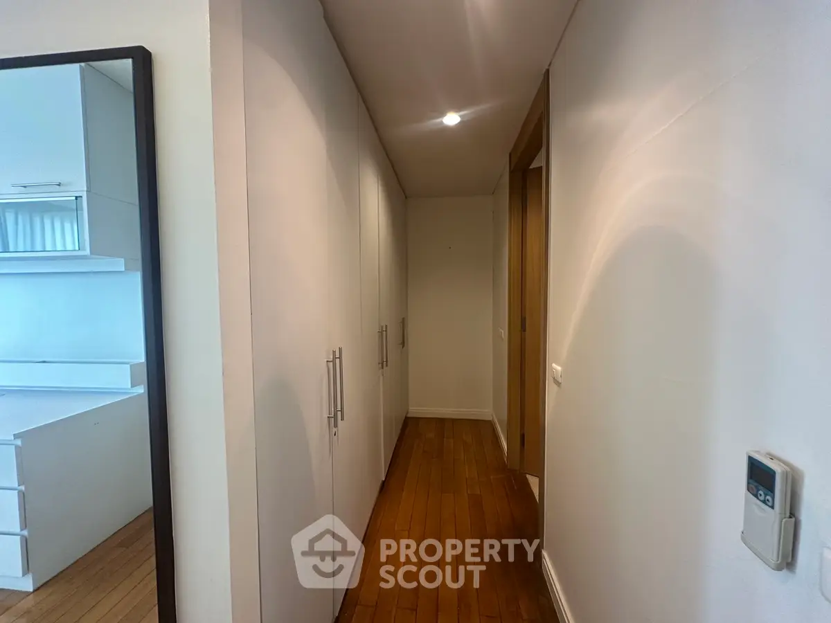 Spacious hallway with built-in storage and modern kitchen view
