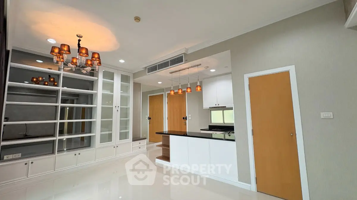 Spacious modern living room with elegant lighting and built-in shelving
