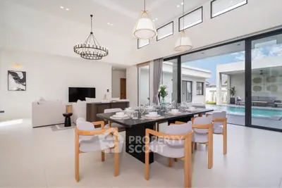Luxurious open-plan living and dining area with pool view, featuring elegant decor and abundant natural light.