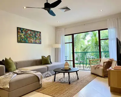 Spacious living room with modern decor and balcony view, perfect for relaxation and entertaining.
