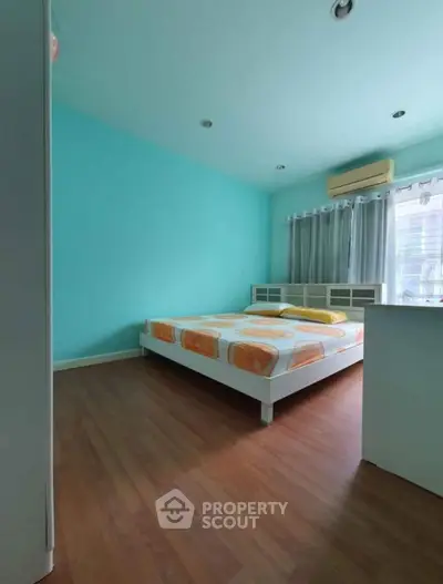 Spacious bedroom with modern decor and natural light