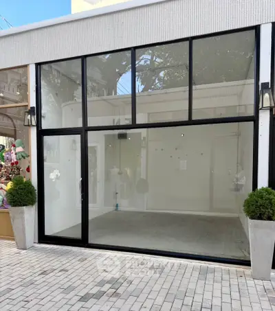 Spacious commercial storefront with large glass windows and modern design.