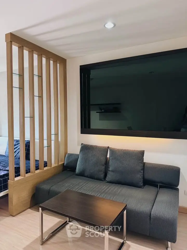 Modern living room with sleek sofa and wooden partition