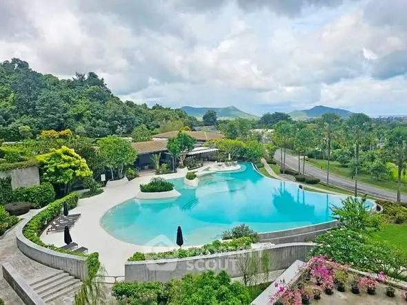 Luxurious resort-style pool with lush greenery and scenic mountain views.