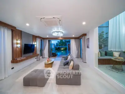 Luxurious modern living room with elegant decor and spacious layout, featuring a stunning view of the outdoor area.