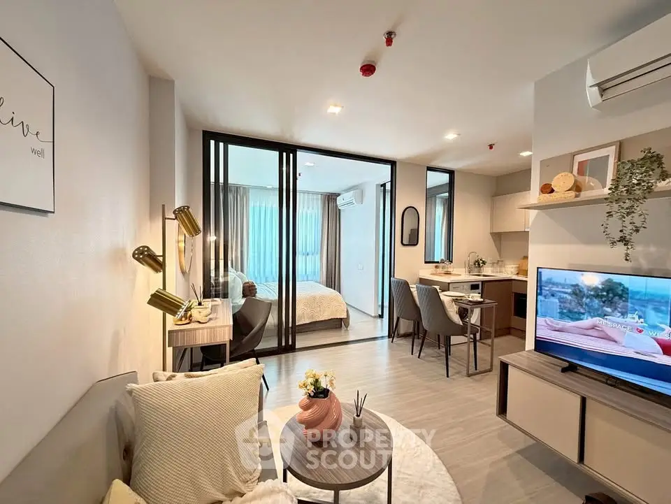 Modern open-plan living room with stylish decor and cozy bedroom view