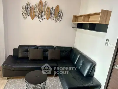 Modern living room with black leather sectional sofa and stylish wall art