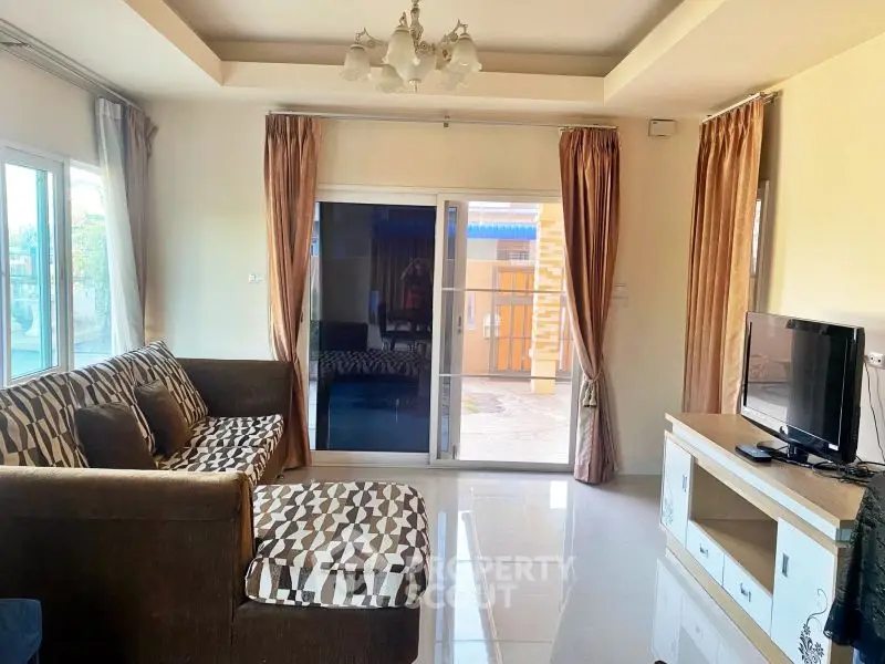 Spacious living room with modern decor and large windows for natural light.