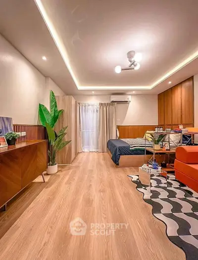 Spacious modern living room with stylish decor and wooden flooring