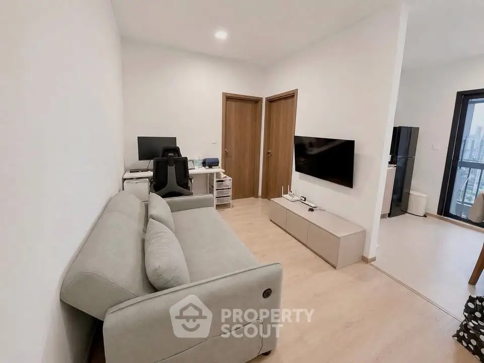 Modern living room with sleek furniture and city view, perfect for urban living.