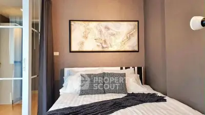 Modern bedroom with stylish decor and cozy ambiance, featuring elegant wall art and soft lighting.