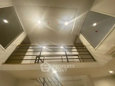 Modern interior with stylish railing and recessed lighting in a contemporary home
