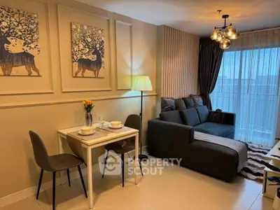 Cozy living room with modern decor and dining area, featuring stylish lighting and elegant wall art.