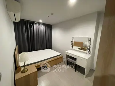 Modern bedroom with sleek furniture and ambient lighting in a stylish apartment.