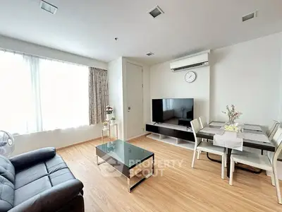 Modern living room with sleek furniture and natural light, perfect for relaxation and entertainment.