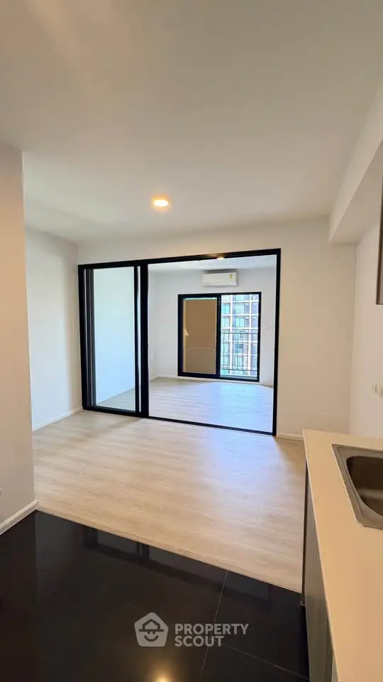 Modern apartment interior with open layout and large windows for natural light.