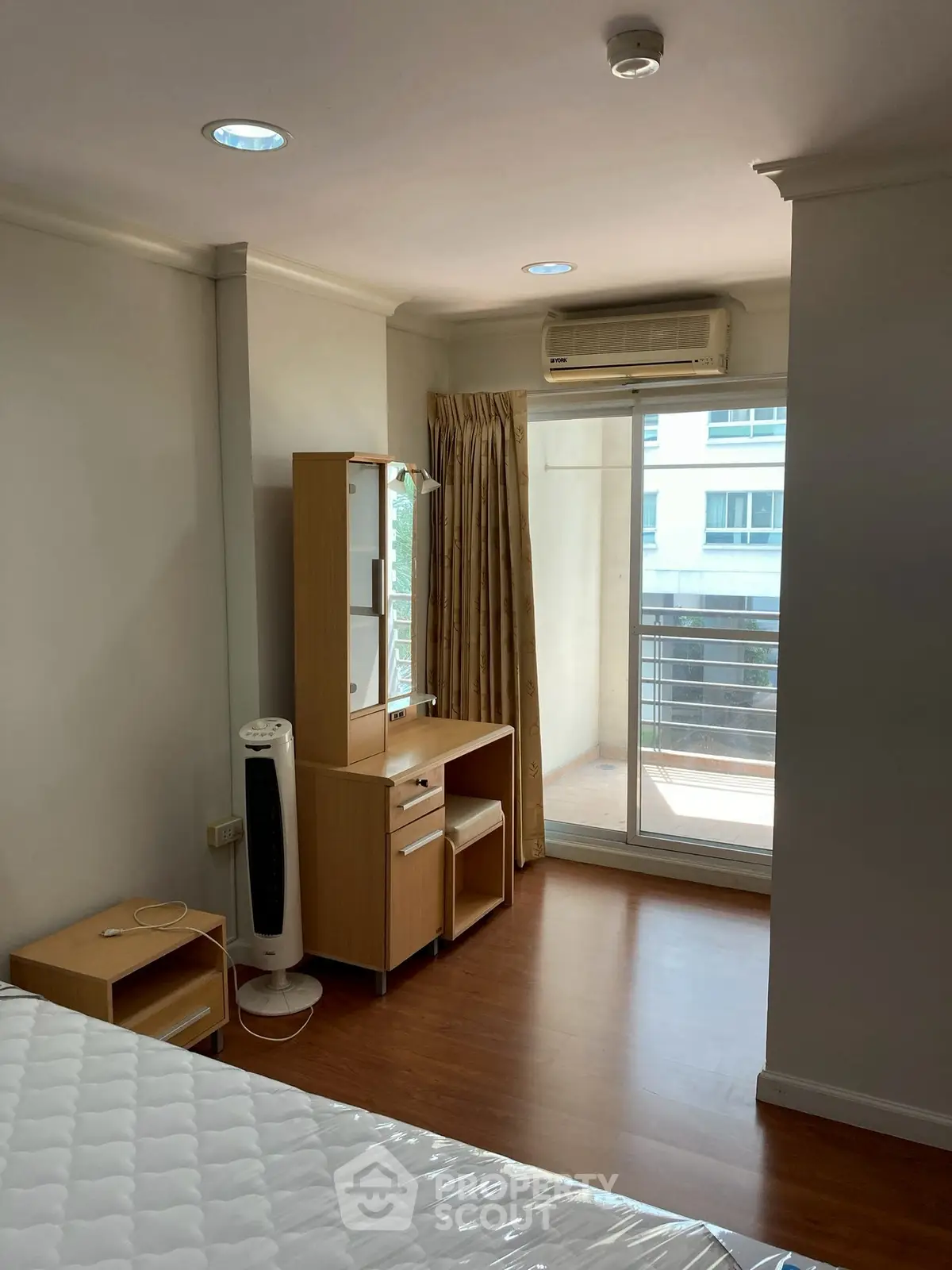 Bright bedroom with balcony access and modern furnishings