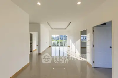 Spacious modern living room with glossy tile flooring and abundant natural light