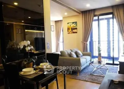 Modern living room with elegant decor and balcony view in a stylish apartment.
