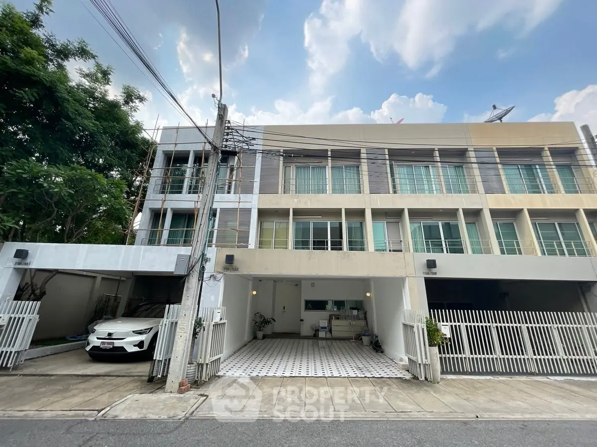 Modern townhouse with spacious parking and sleek exterior design in a serene neighborhood.