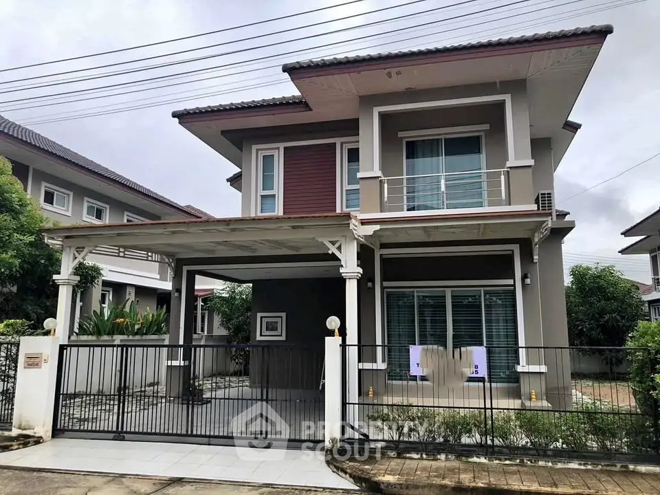 Modern two-story house with a spacious driveway and contemporary design.