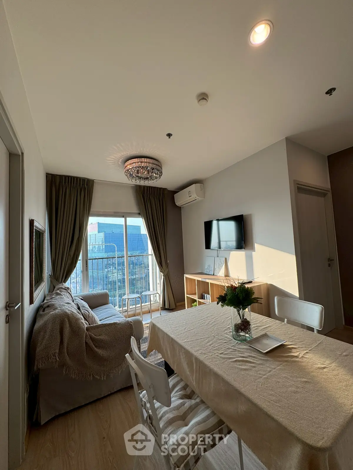 Charming living room with elegant decor and city view, featuring cozy seating and modern amenities.