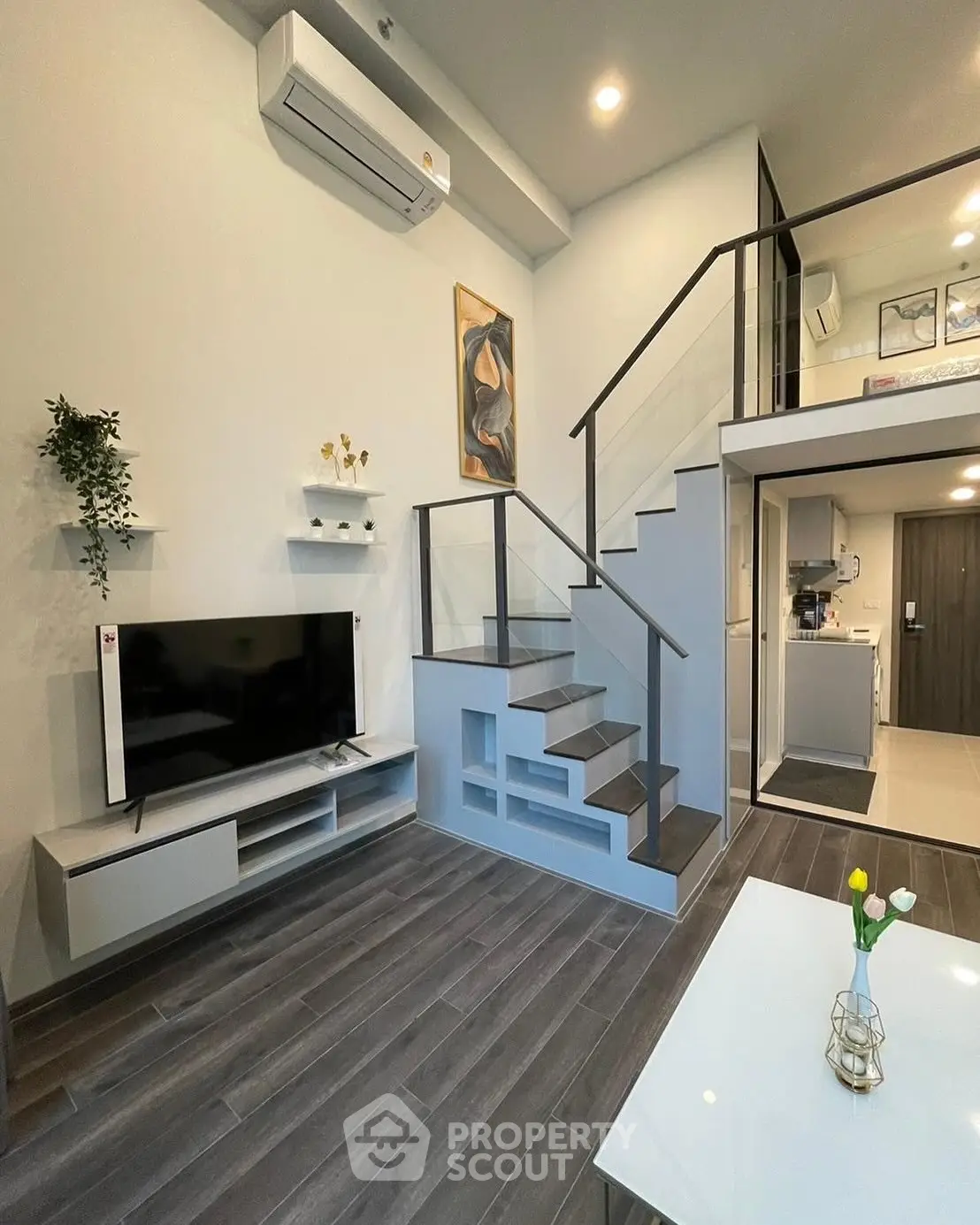 Modern duplex living room with sleek staircase and stylish decor