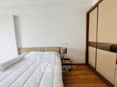 Modern bedroom with sleek wardrobe and cozy bed in minimalist style.