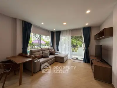 Spacious living room with modern decor and large windows for natural light.
