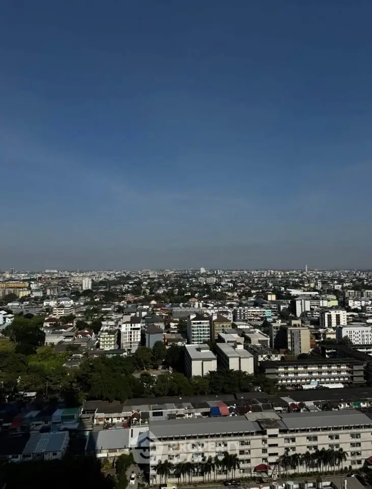 Stunning cityscape view showcasing expansive urban skyline under clear blue skies.