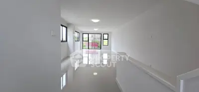 Spacious modern living room with large windows and glossy floors