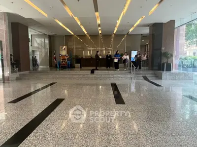 Elegant entrance of Sathorn Nakorn Tower with modern design and spacious lobby area.