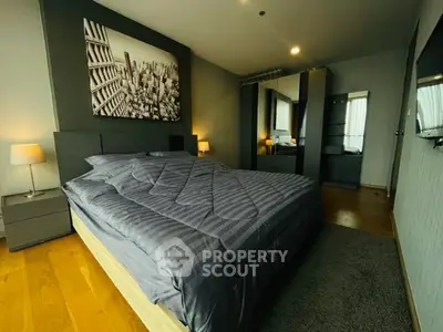 Modern bedroom with stylish decor and cozy ambiance, featuring a large bed and mirrored wardrobe.