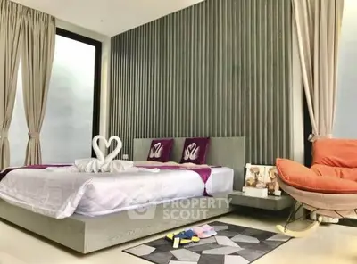 Luxurious modern bedroom with elegant decor and large windows for natural light.